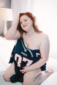 woman posing with husbands favorite sports jersey