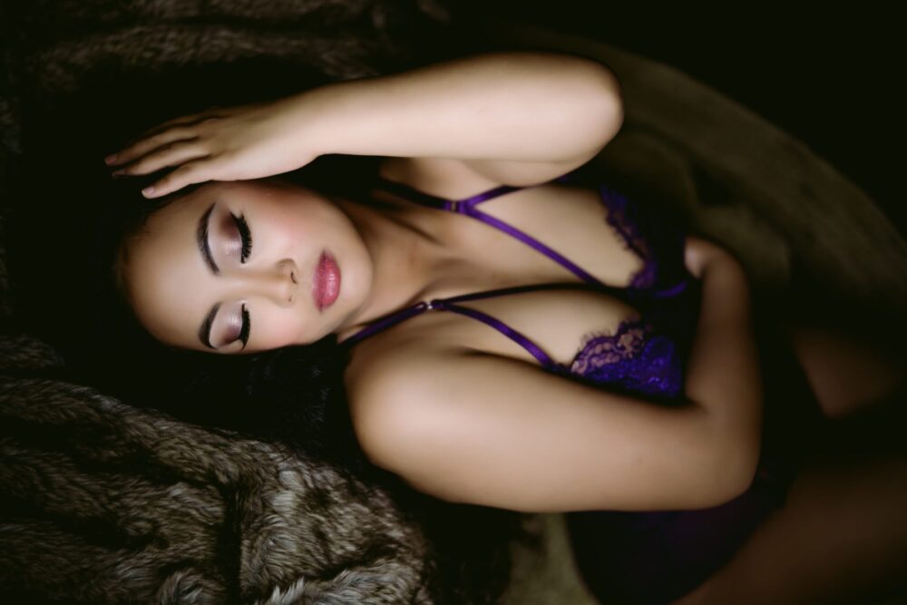 beautiful woman posing with eyes closed and hand on her head