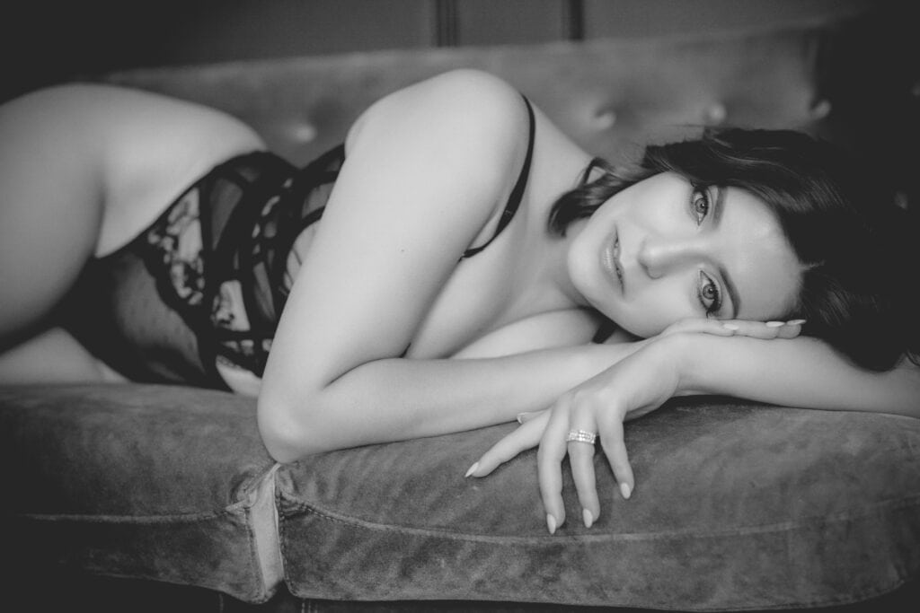 A woman reclining on a couch in black and white for Northern Virginia Boudoir Photography.
