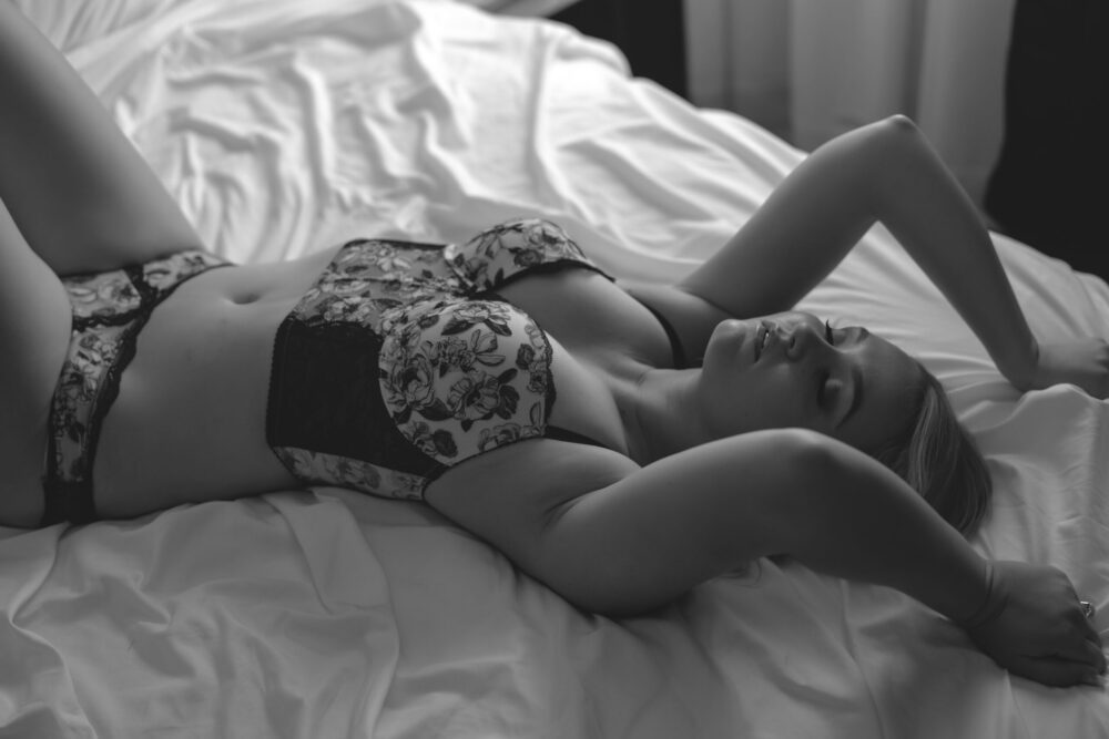 A woman in lingerie lounging on a bed, captured by Northern Virginia Boudoir Photography.