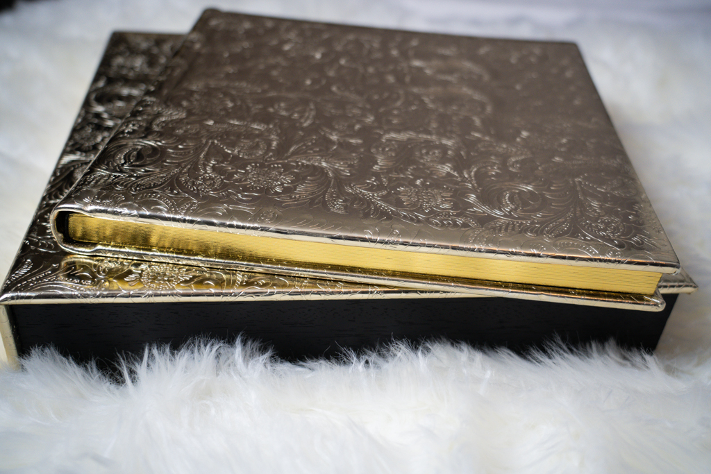 A gold and black book rests on a furry blanket in this luxurious photo by Kellie Frye Photography.