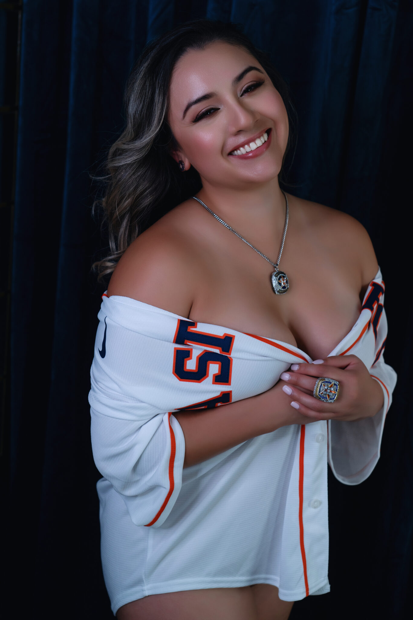 A woman in a baseball shirt is posing for a photo as part of Northern Virginia Boudoir Photography.